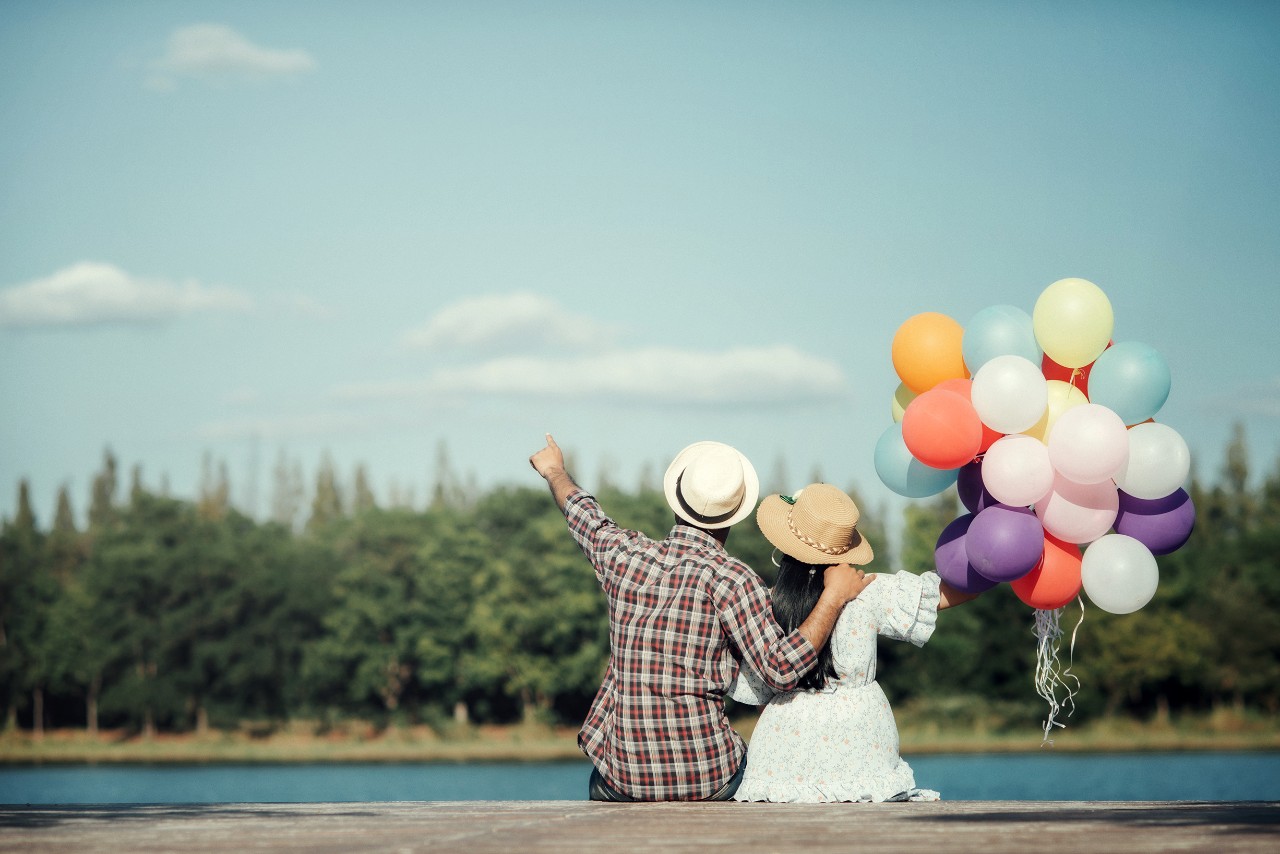 Portrait of a couple in love with balloons colorful