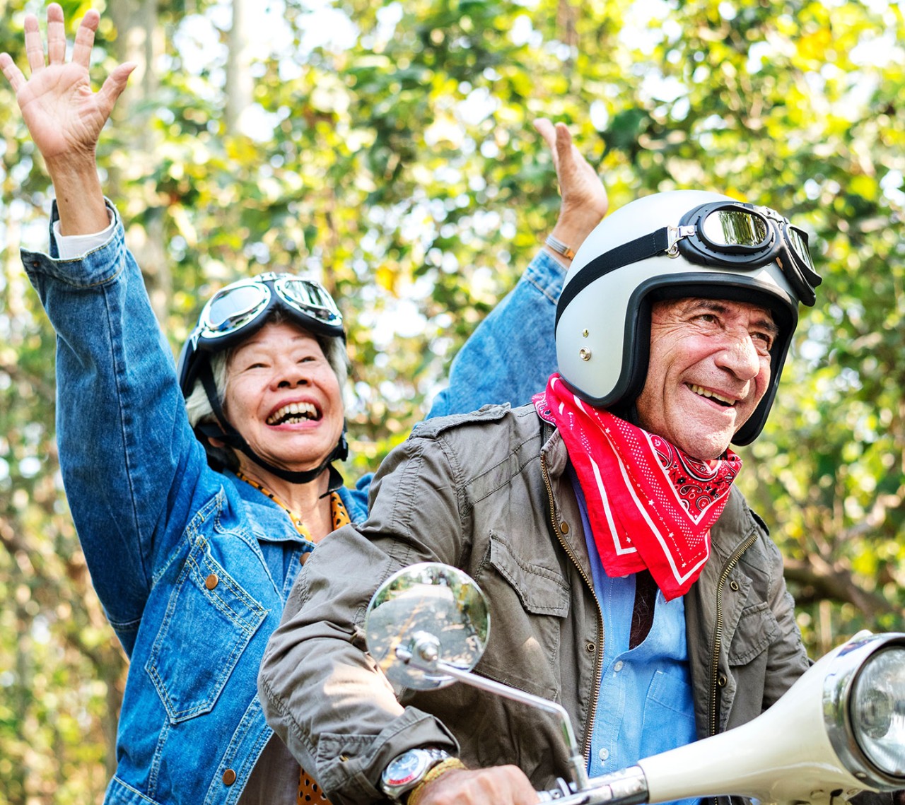 Senior couple riding a classic scooter